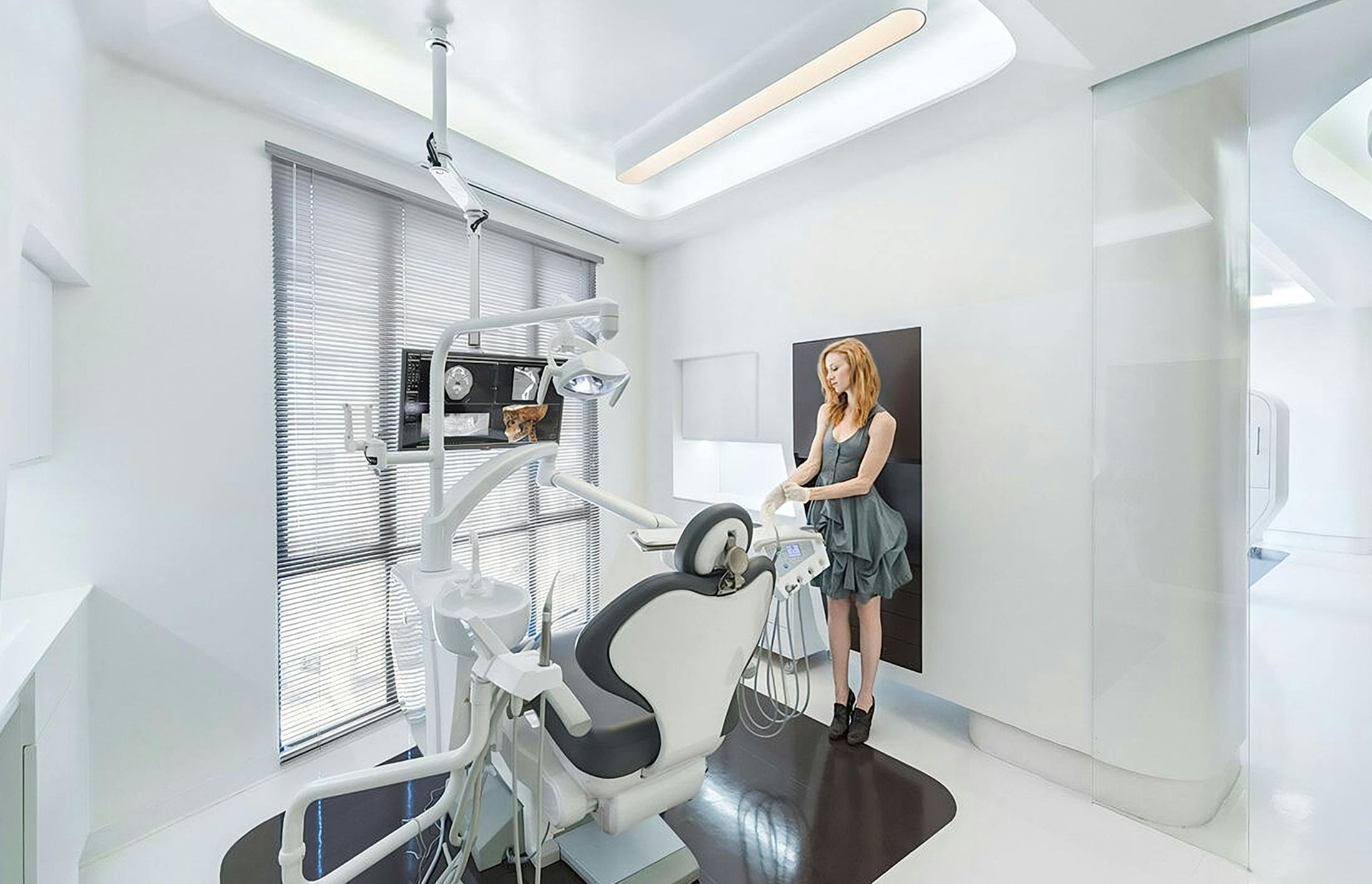 A woman standing in a dentist treatment room