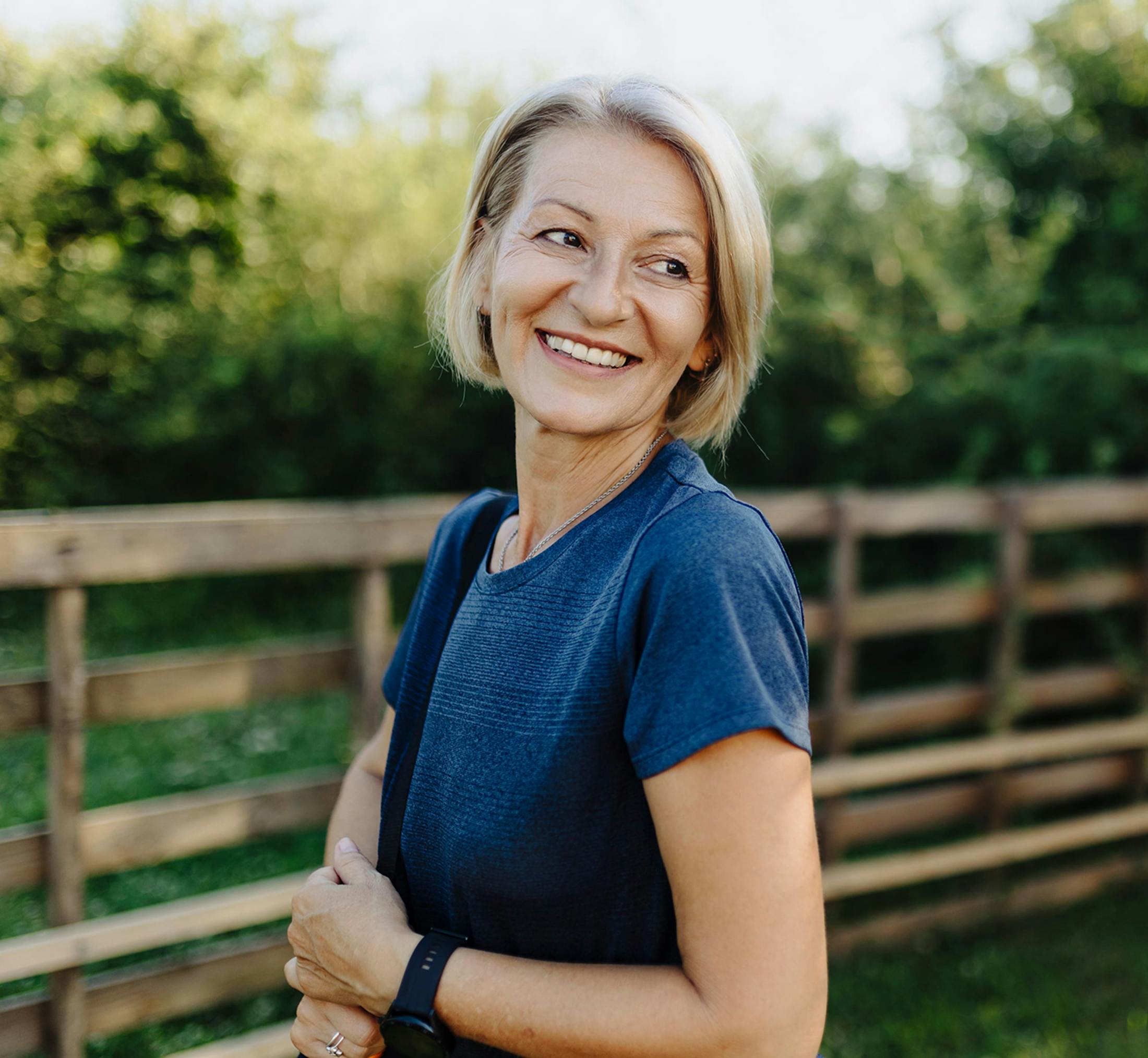 A woman smiling and looking over he shoulder