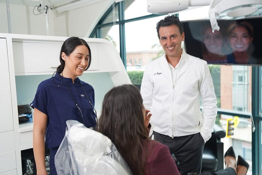 Photo of Dr. Daniel Naysan of Bedford Dental Group in Beverly Hills working with a patient.
