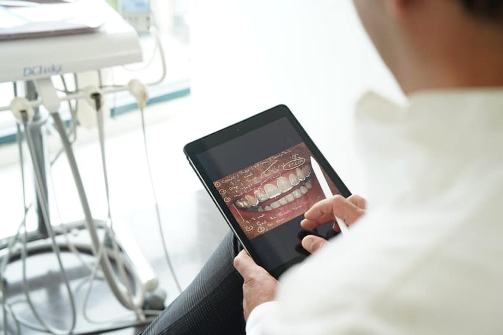 dentist looking at an xray of teeth