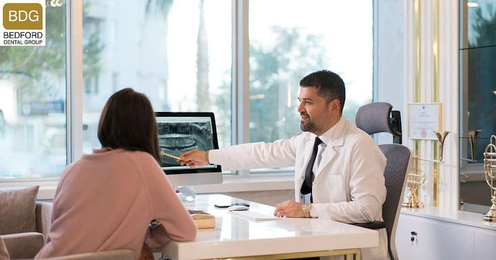 dentist showing patient xrays