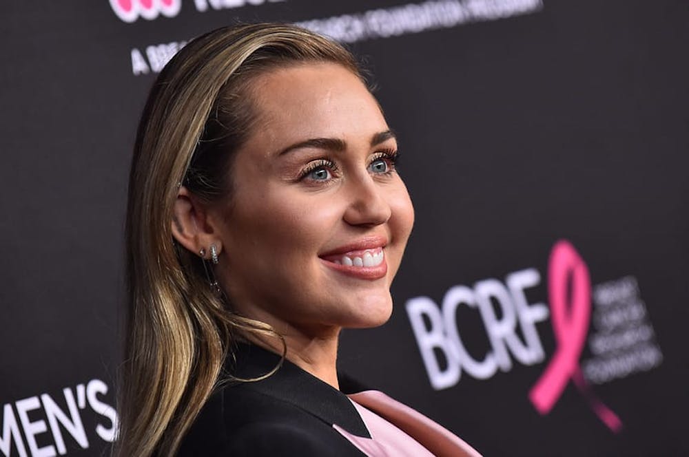 Miley Cyrus smiling on the red carpet in Los Angeles