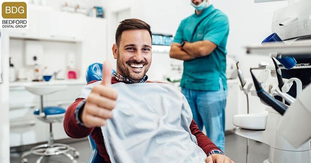 dental patient giving a thumbs up