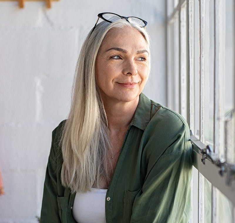 woman leaning against window