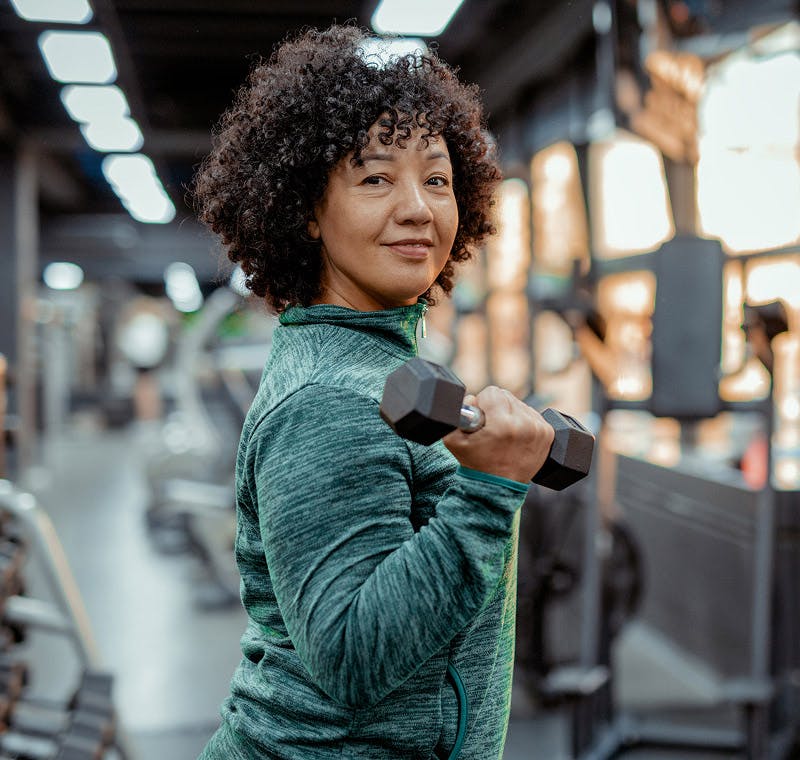 woman at the gym with dumbell in hand