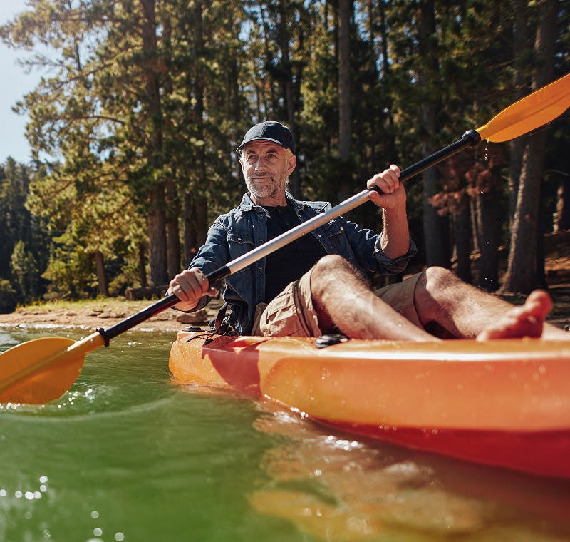 man kayaking in river