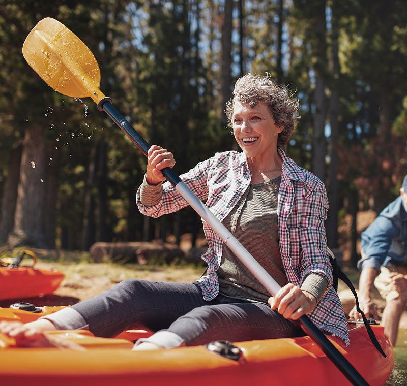 woman kayaking and smiling