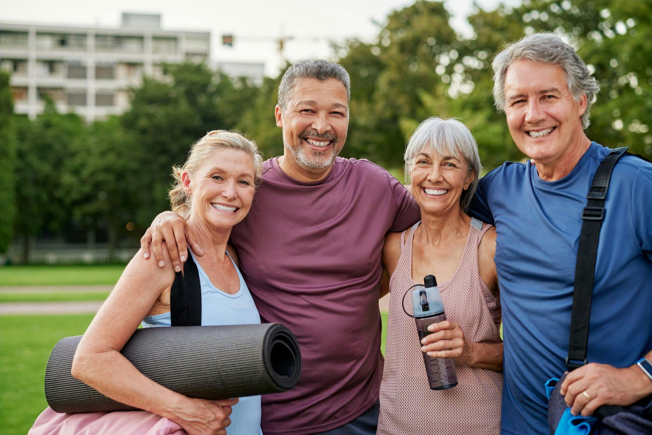 group of men and women smiling all ready for workout