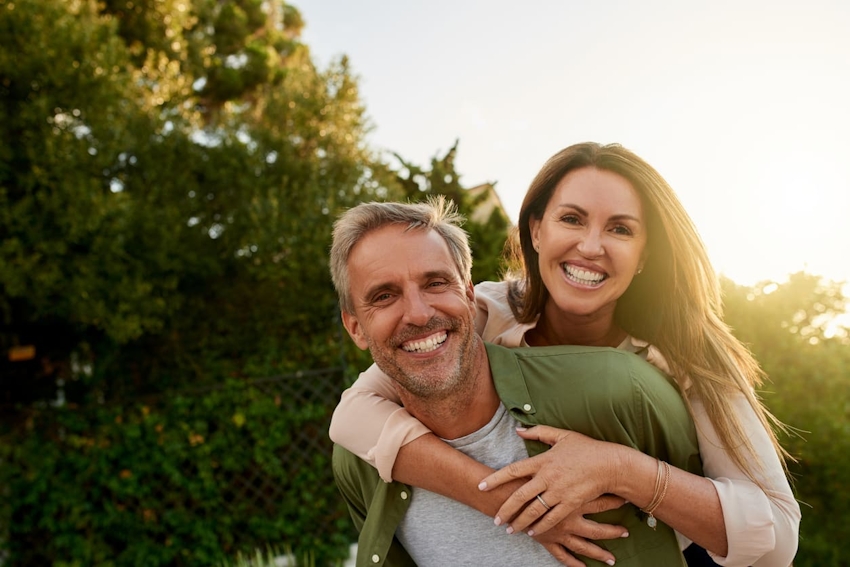 man giving woman a piggyback ride