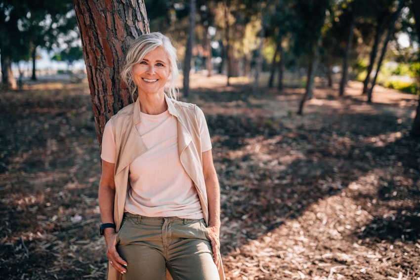 woman leaning against tree