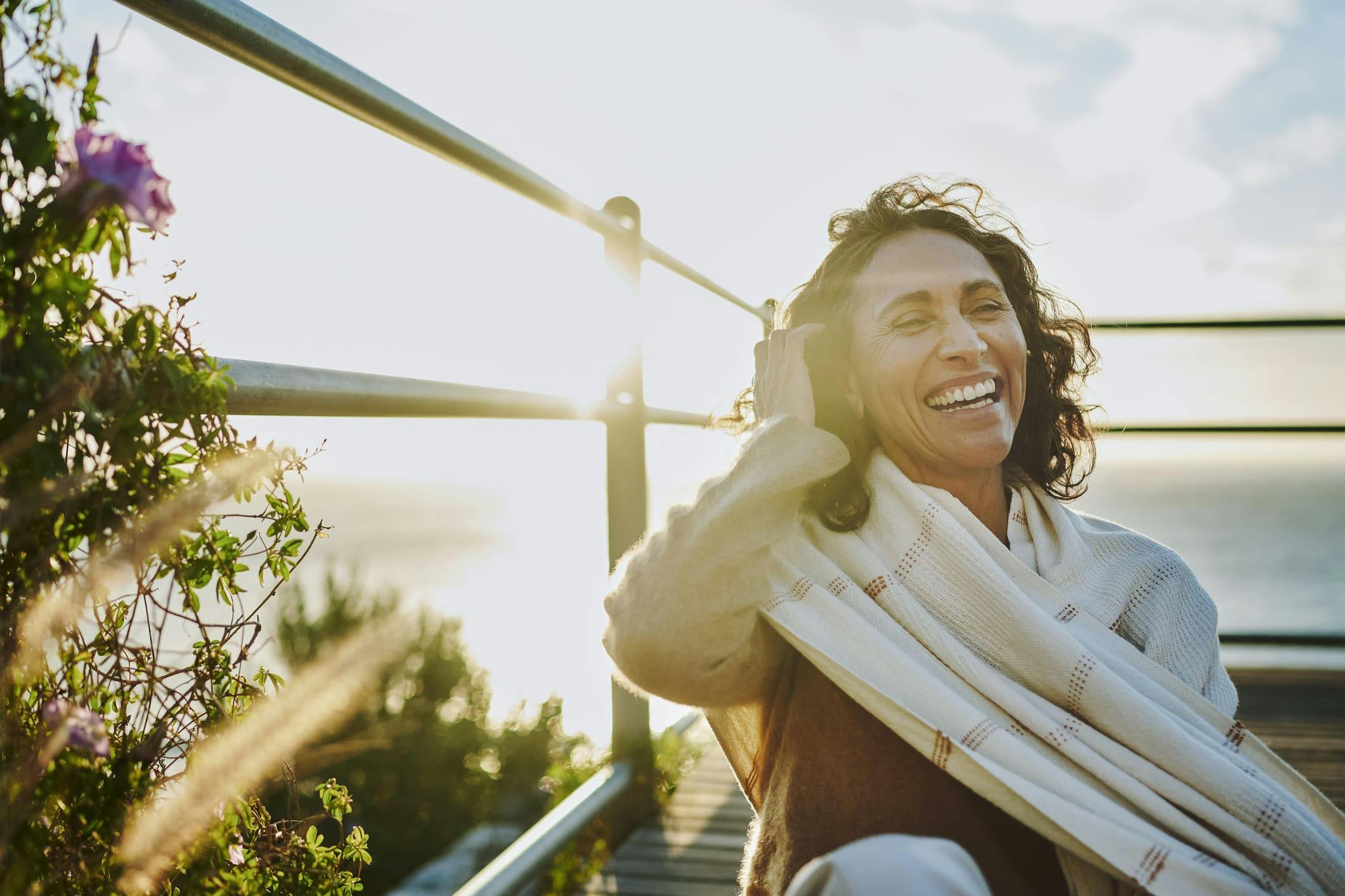 woman sitting on bench next to railing