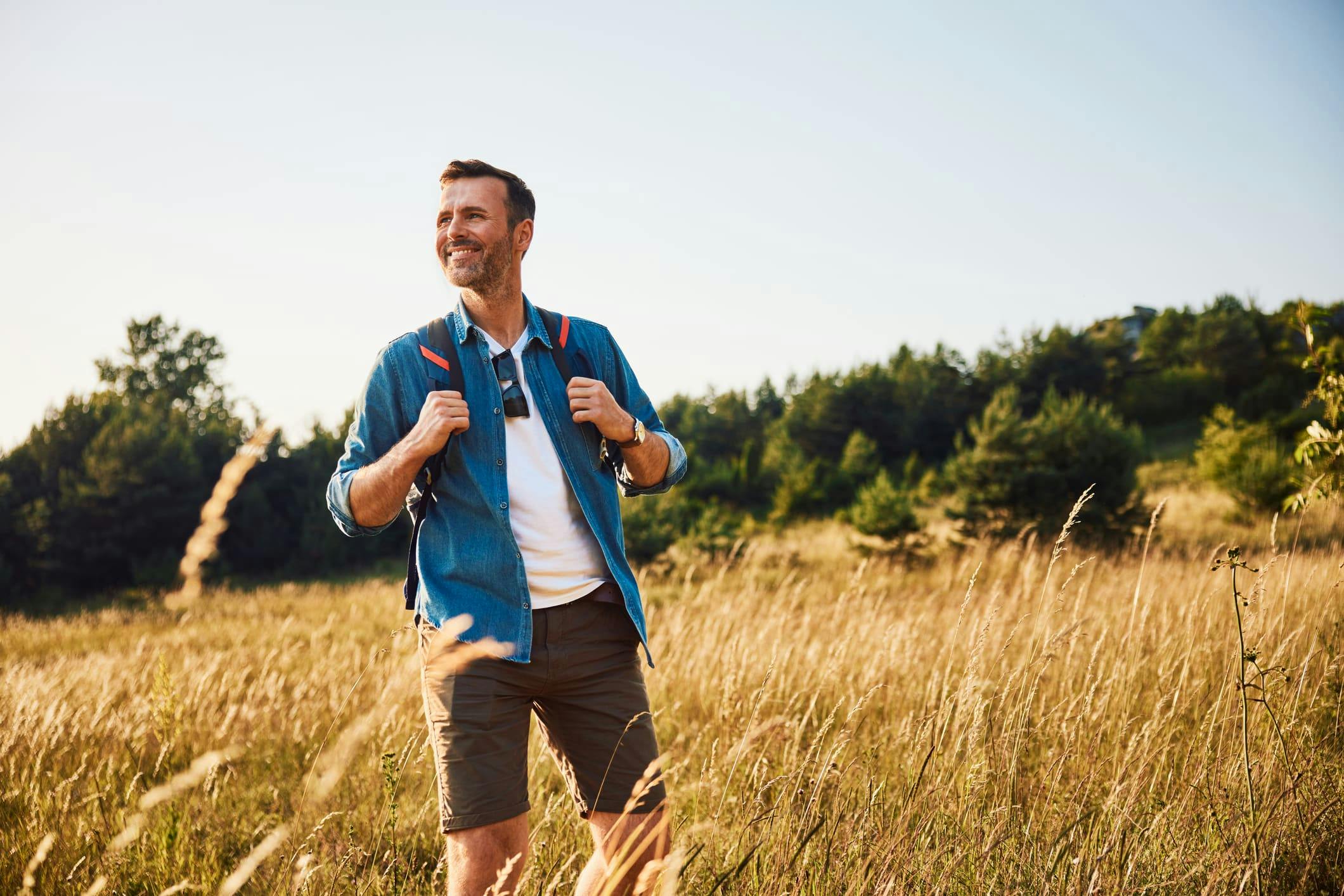 man on a hike in a field