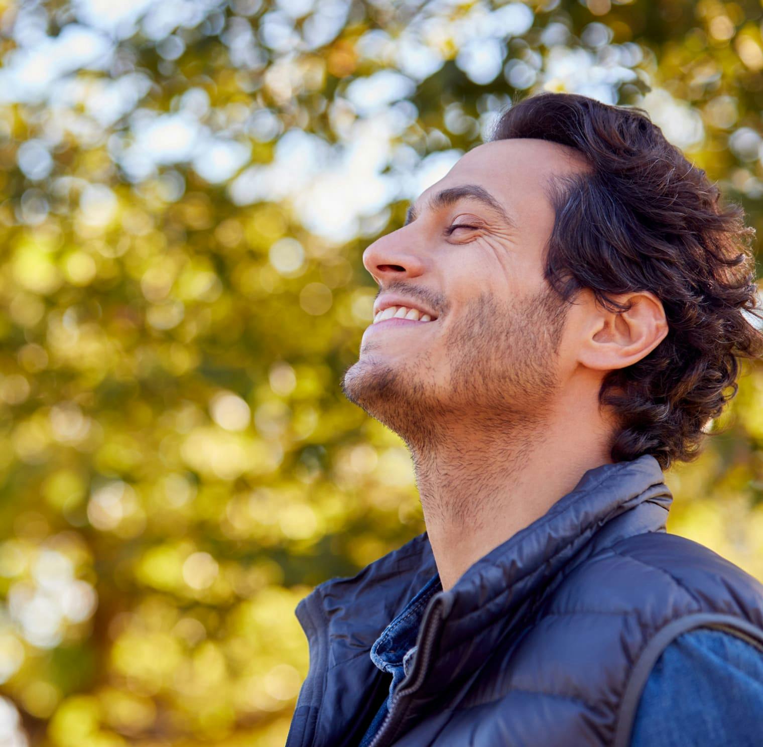 man outside looking at trees