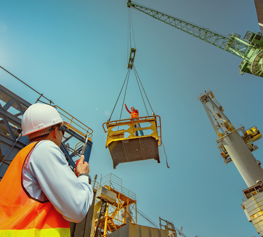 Men on construction site using a crane