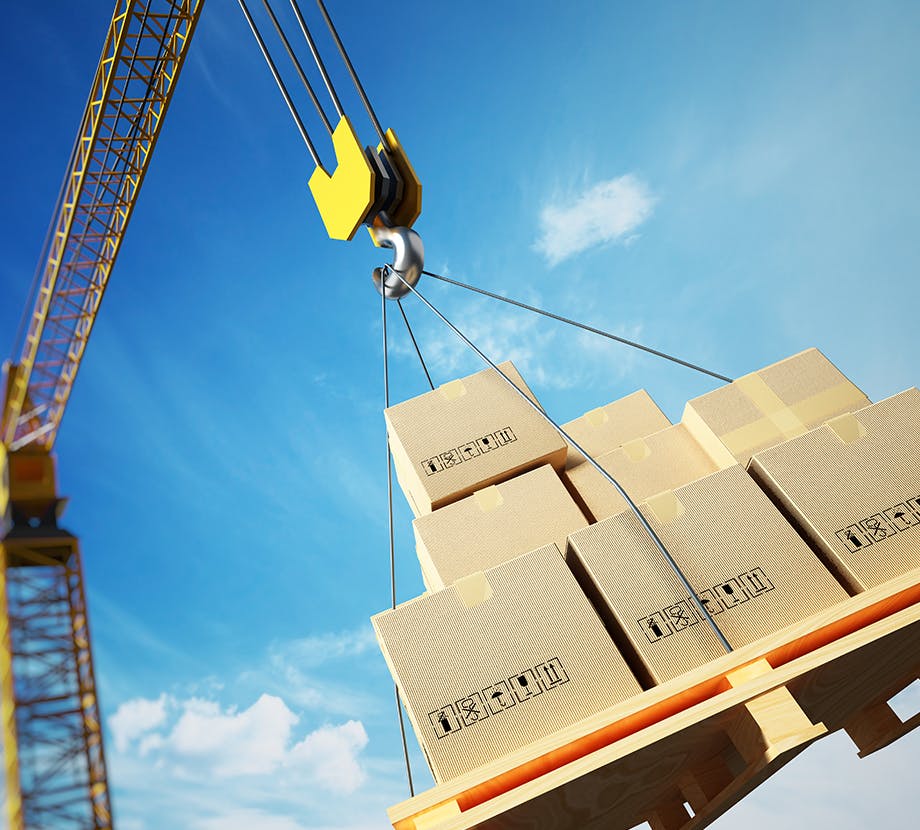 Crane carrying a heavy load of boxes