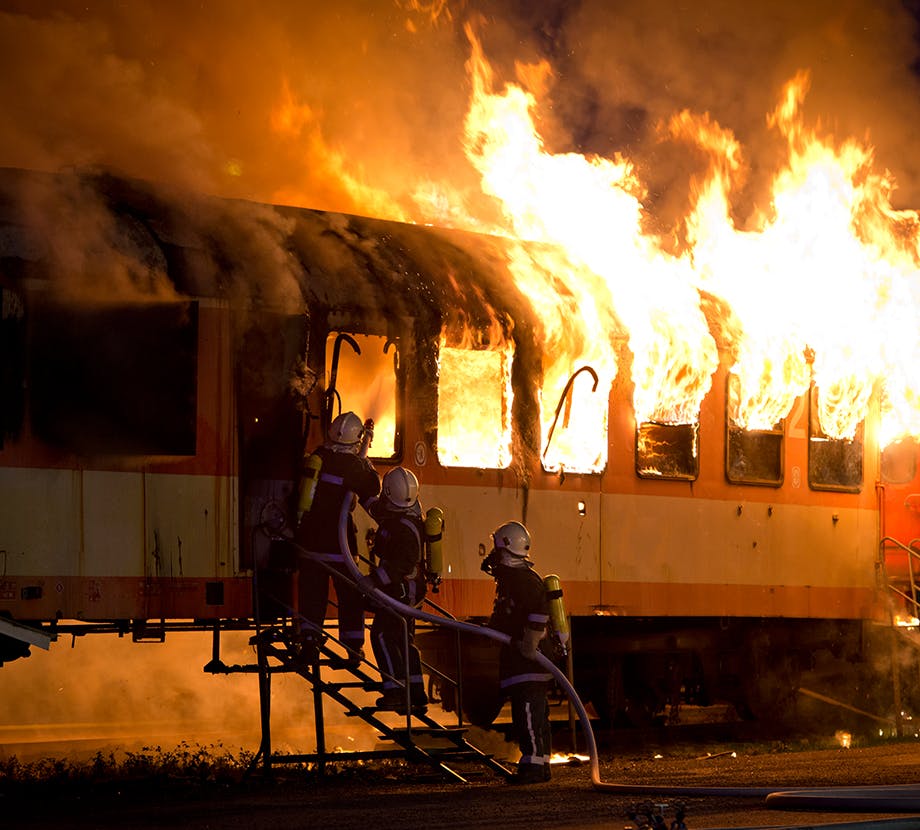 Firefighters attempting to put out a fire on a train