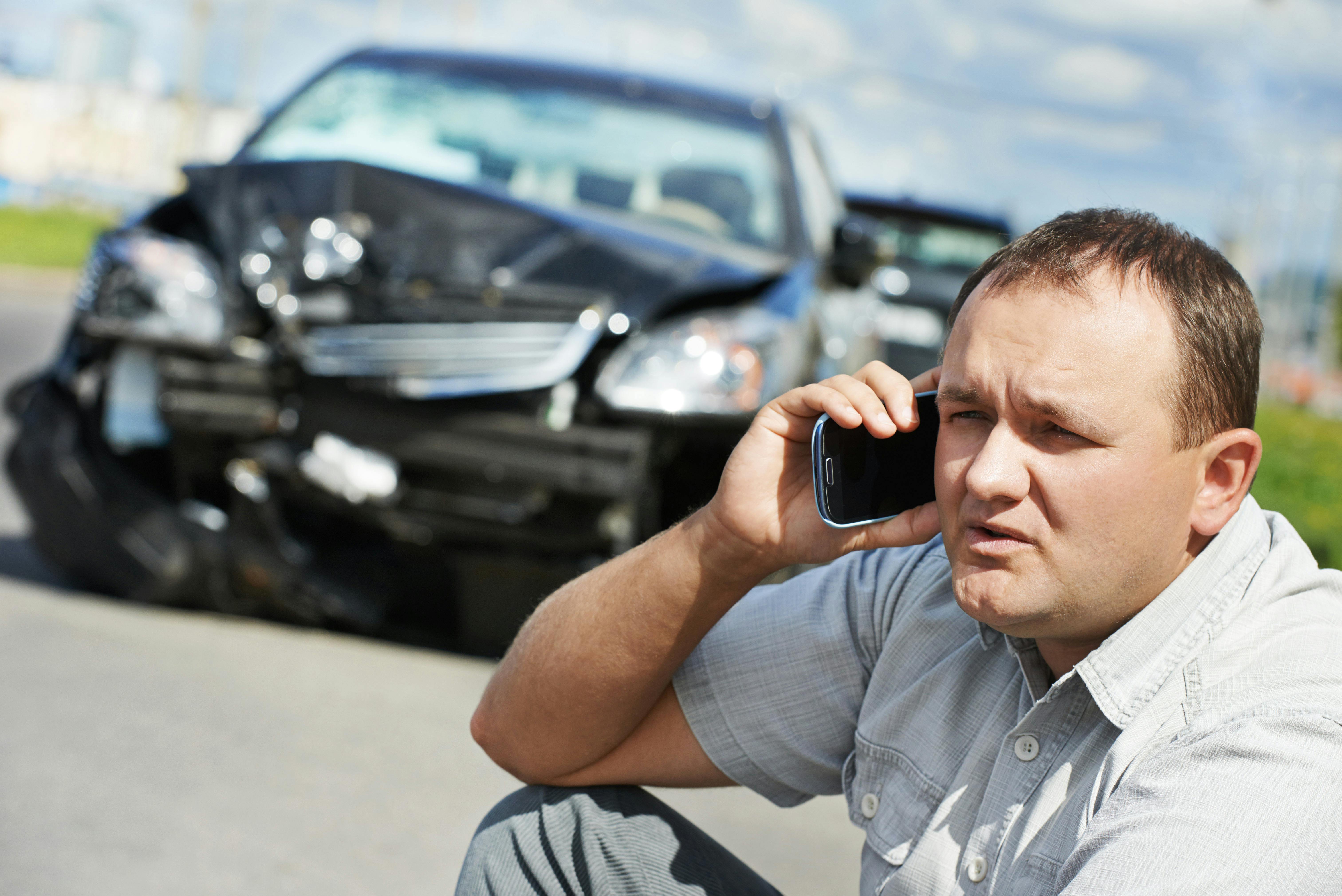 Man on the phone after a car accident