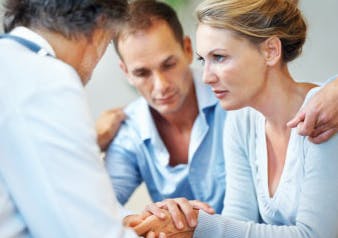 Man trying to console woman