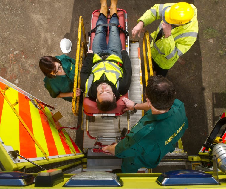 Man being carried into EMS vehicle