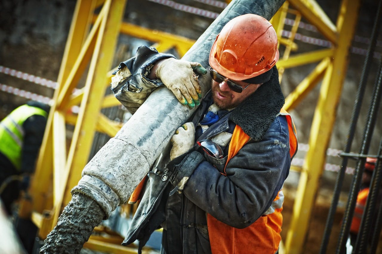 Construction worker pouring cement