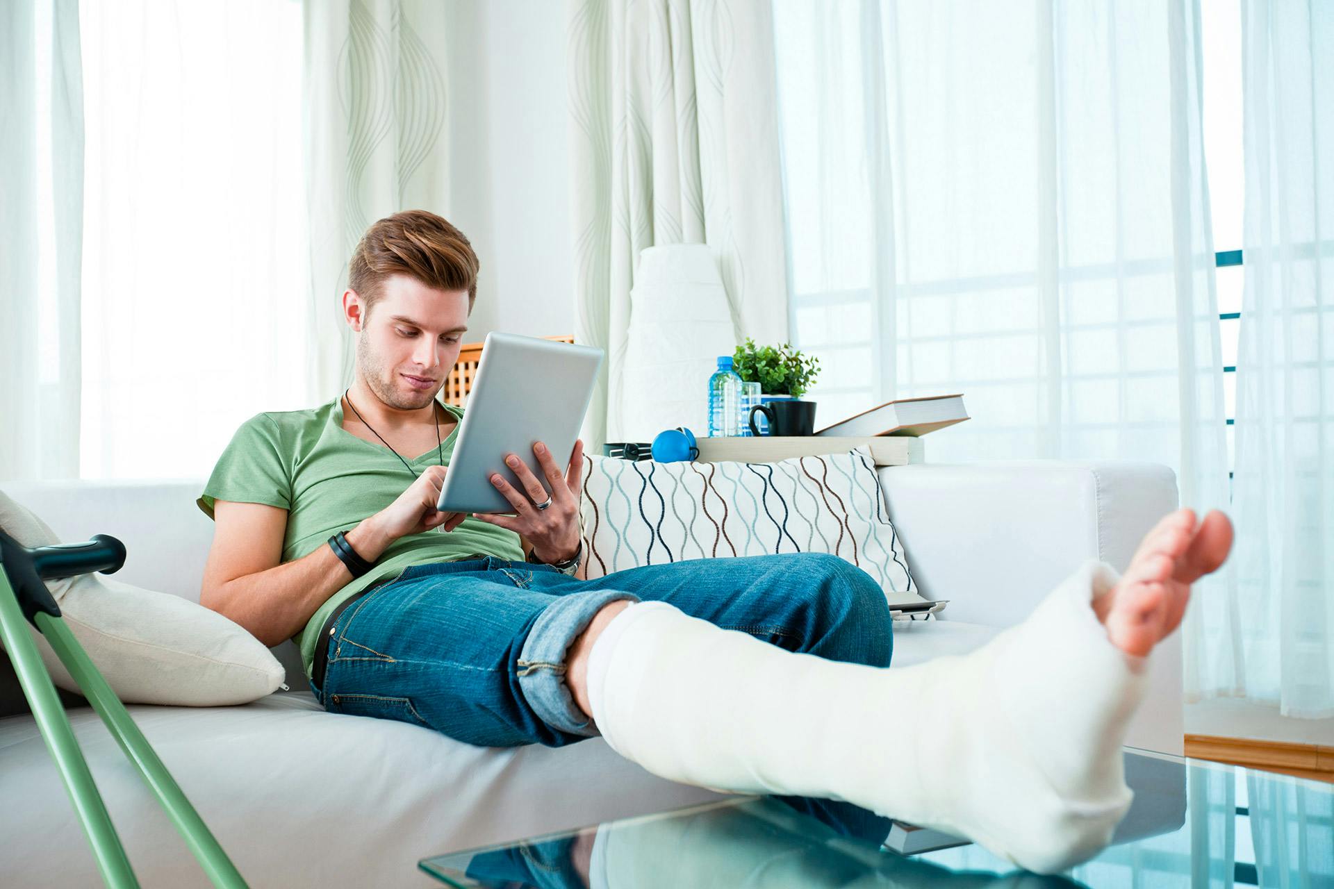 Injured man using tablet