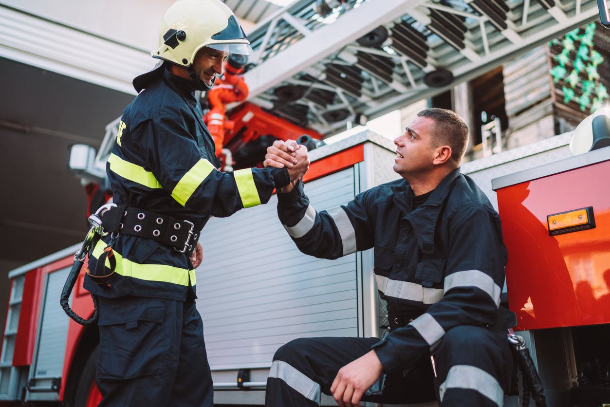 Two firefighters shaking hands