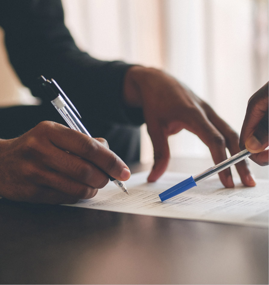 Person signing a document - close up of their hands