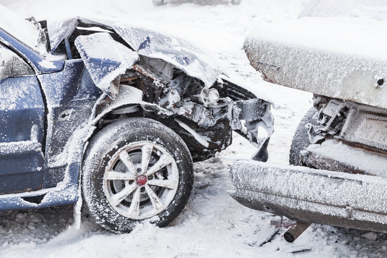 Two cars crashing on a snowy road
