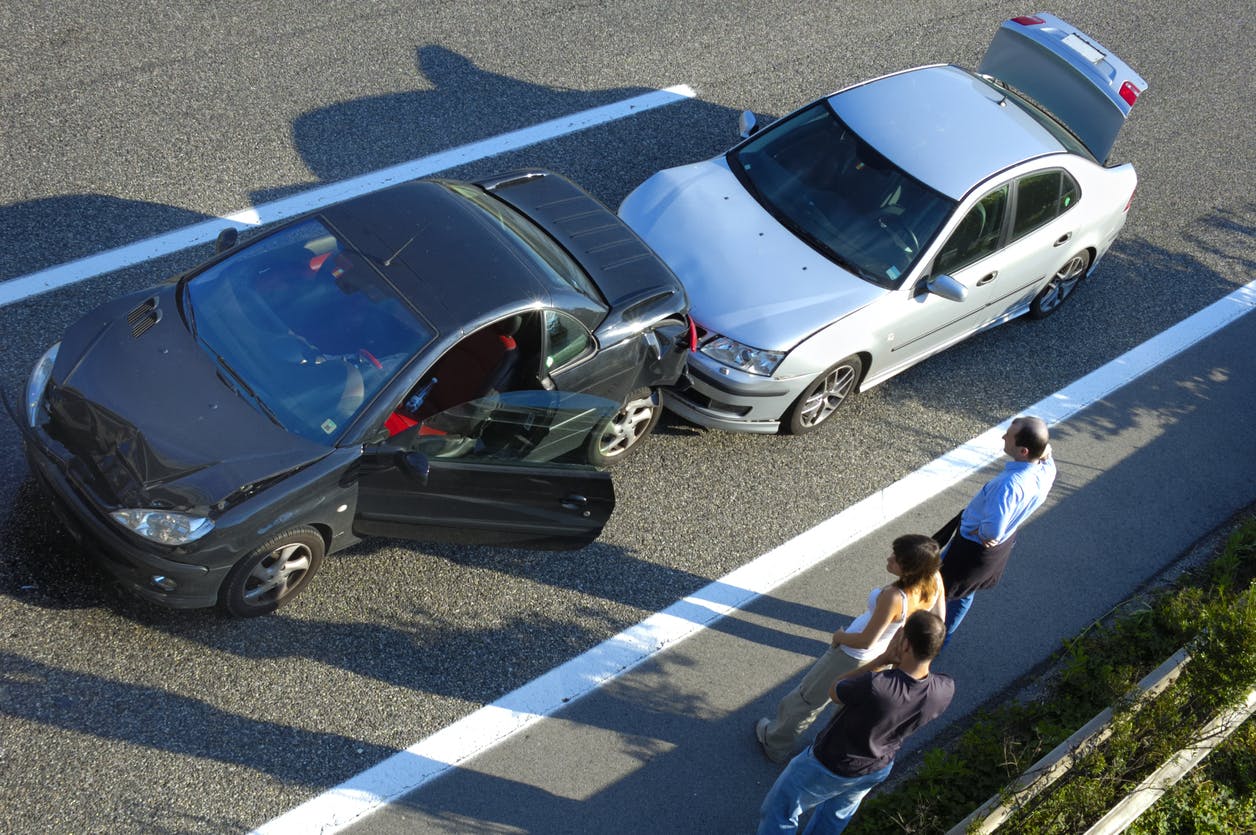 Two-car accident with people standing by