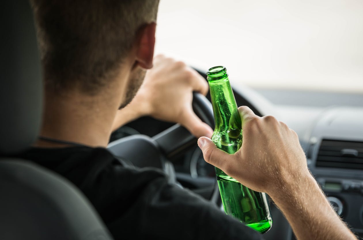 Man drinking while driving car