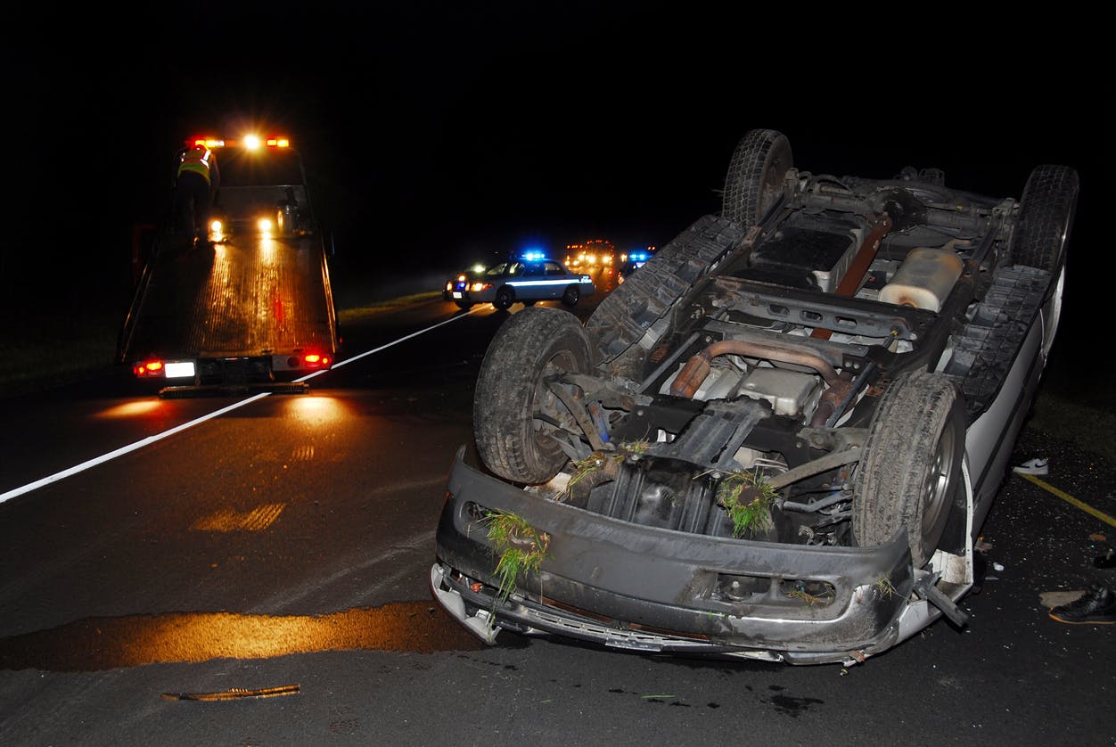 Car accident with vehicle upside down.