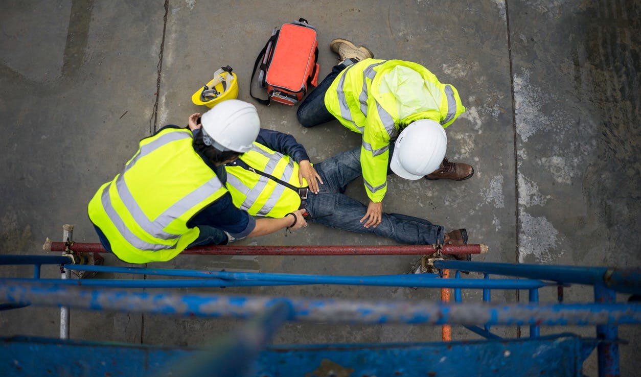 Man being helped after injury on construction job