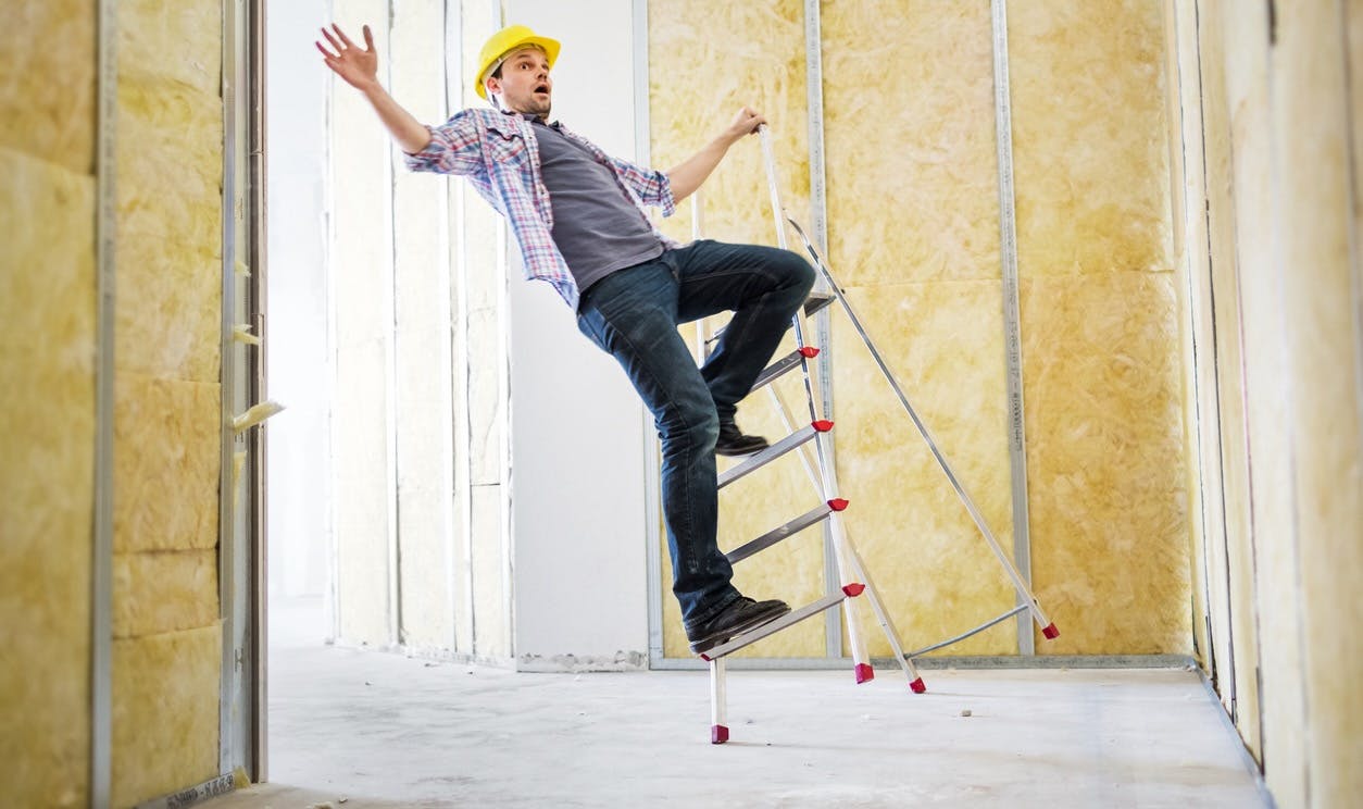 Construction worker falling off ladder