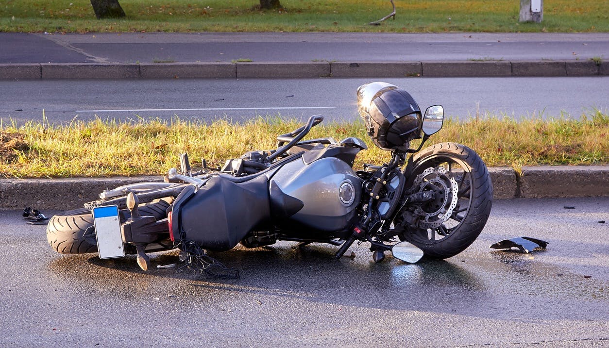 Upturned motorcycle on a road after getting into an accident