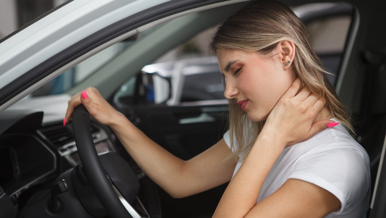 Woman holding her neck in discomfort