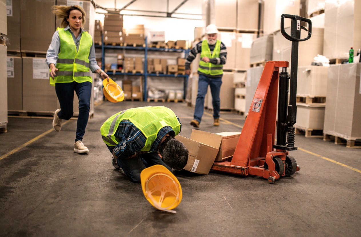Man kneeling over after injury at work