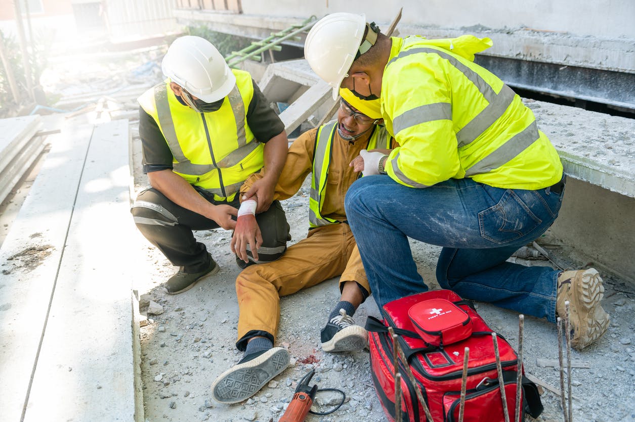 Man being treated for injury on construction site