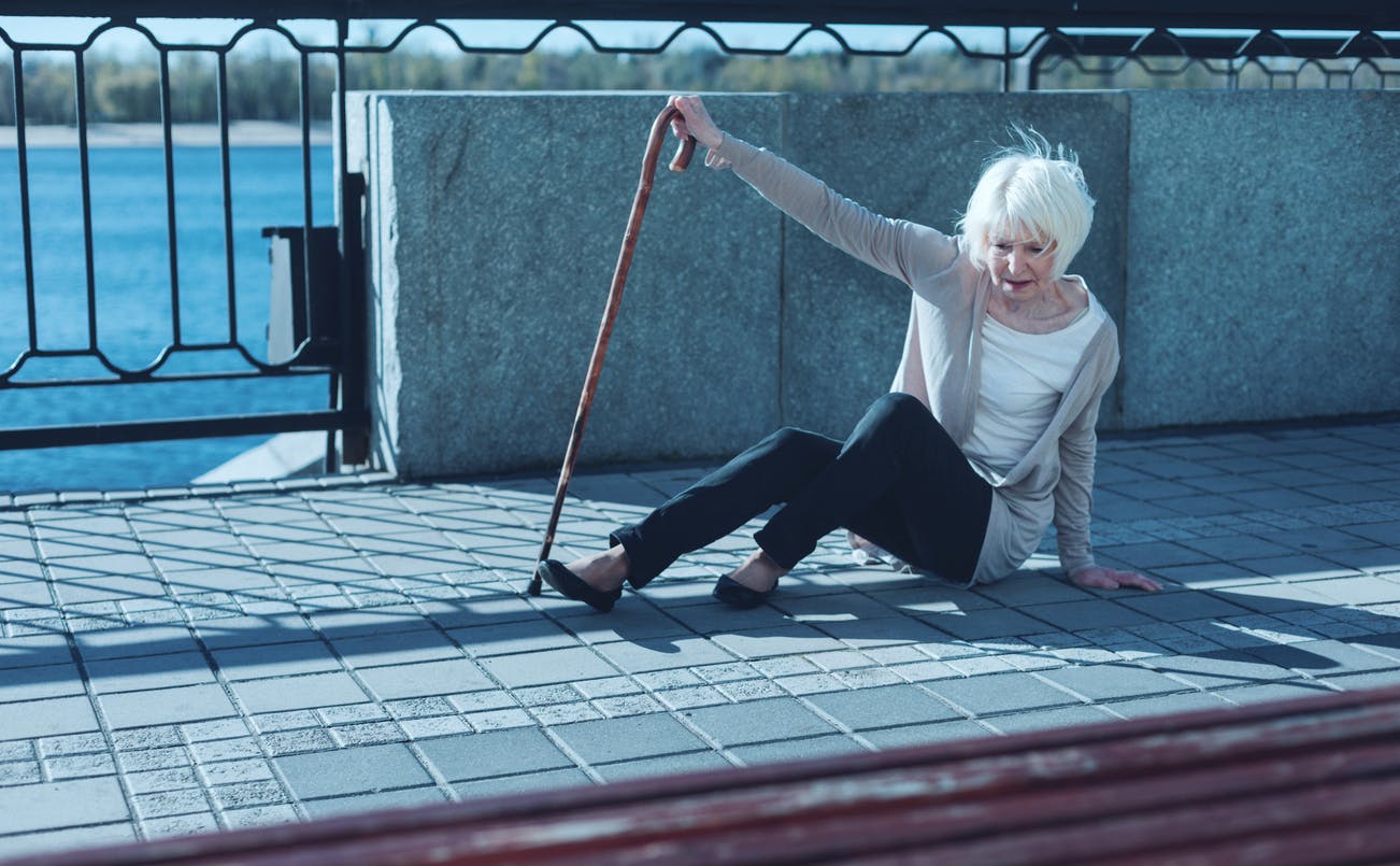 Woman with a cane on the ground