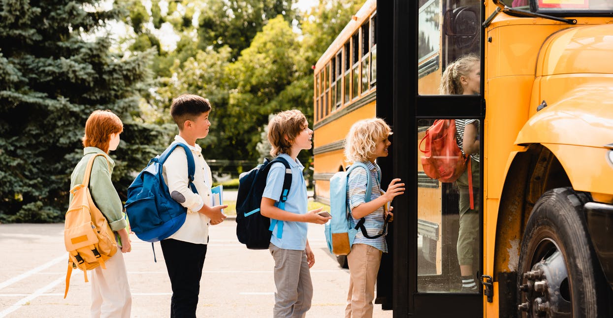 Kids walking onto a school bus
