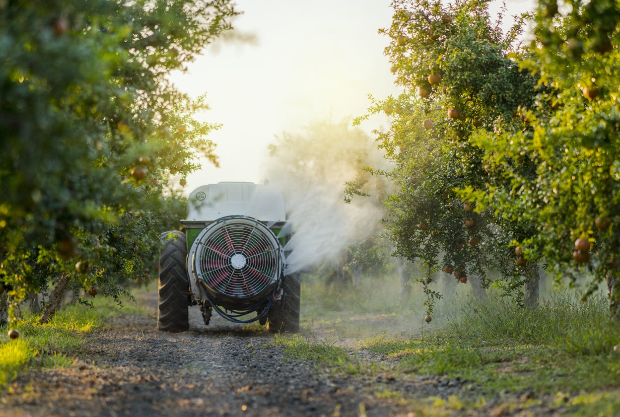 Farm equipment spraying pesticides