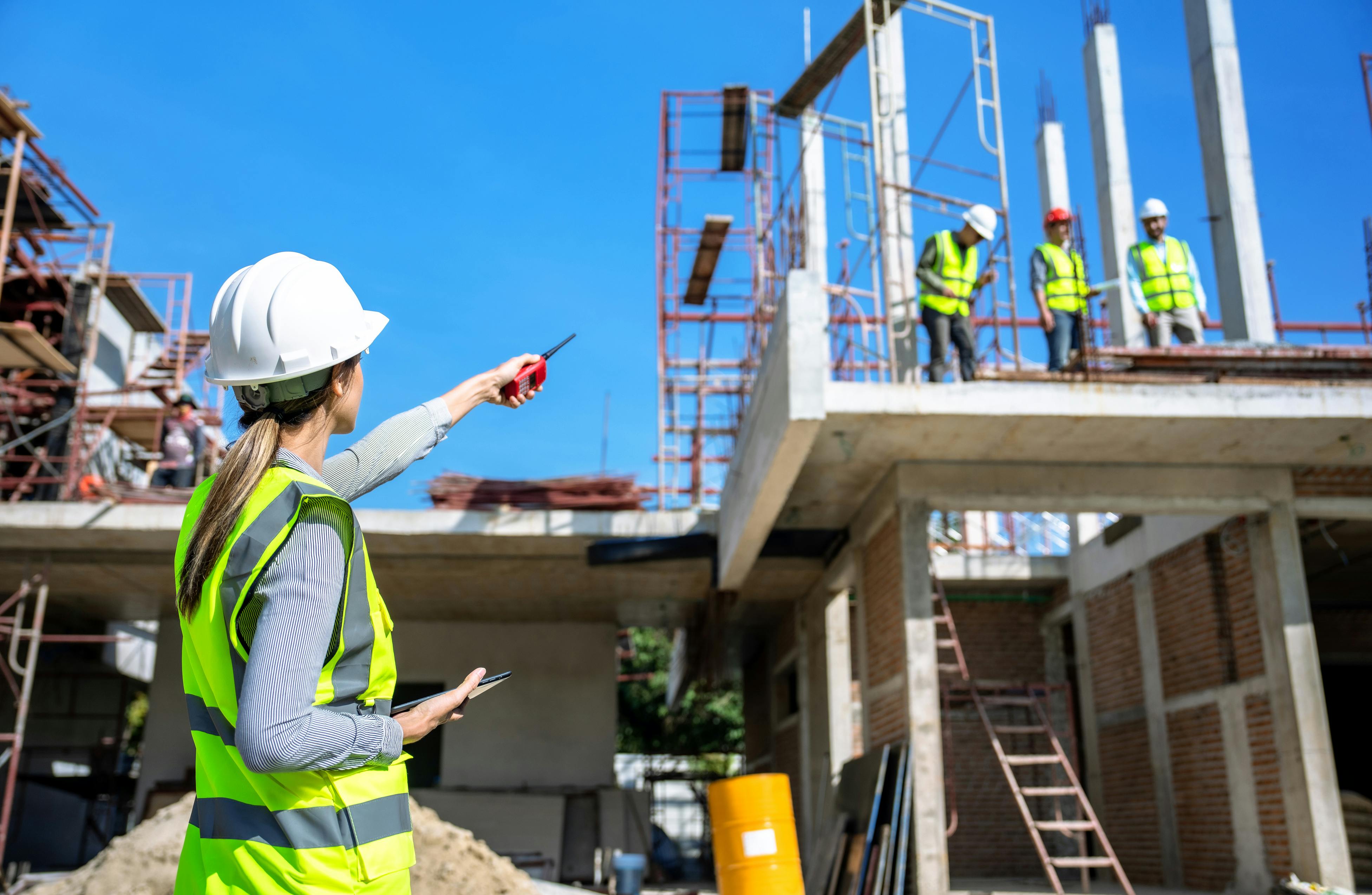 Engineer instructing construction workers on project