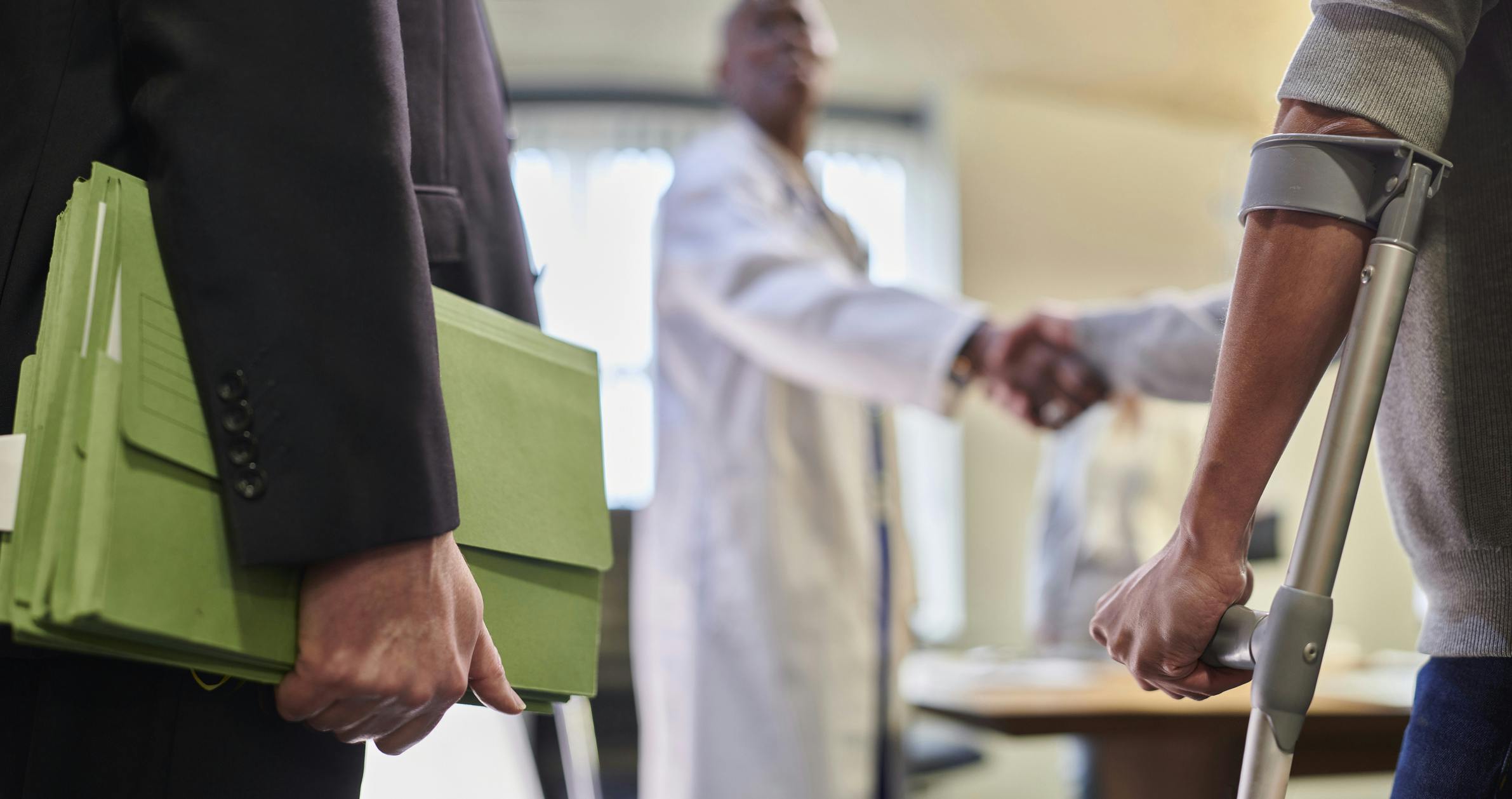 Patient, doctor, and lawyer meeting over personal injury