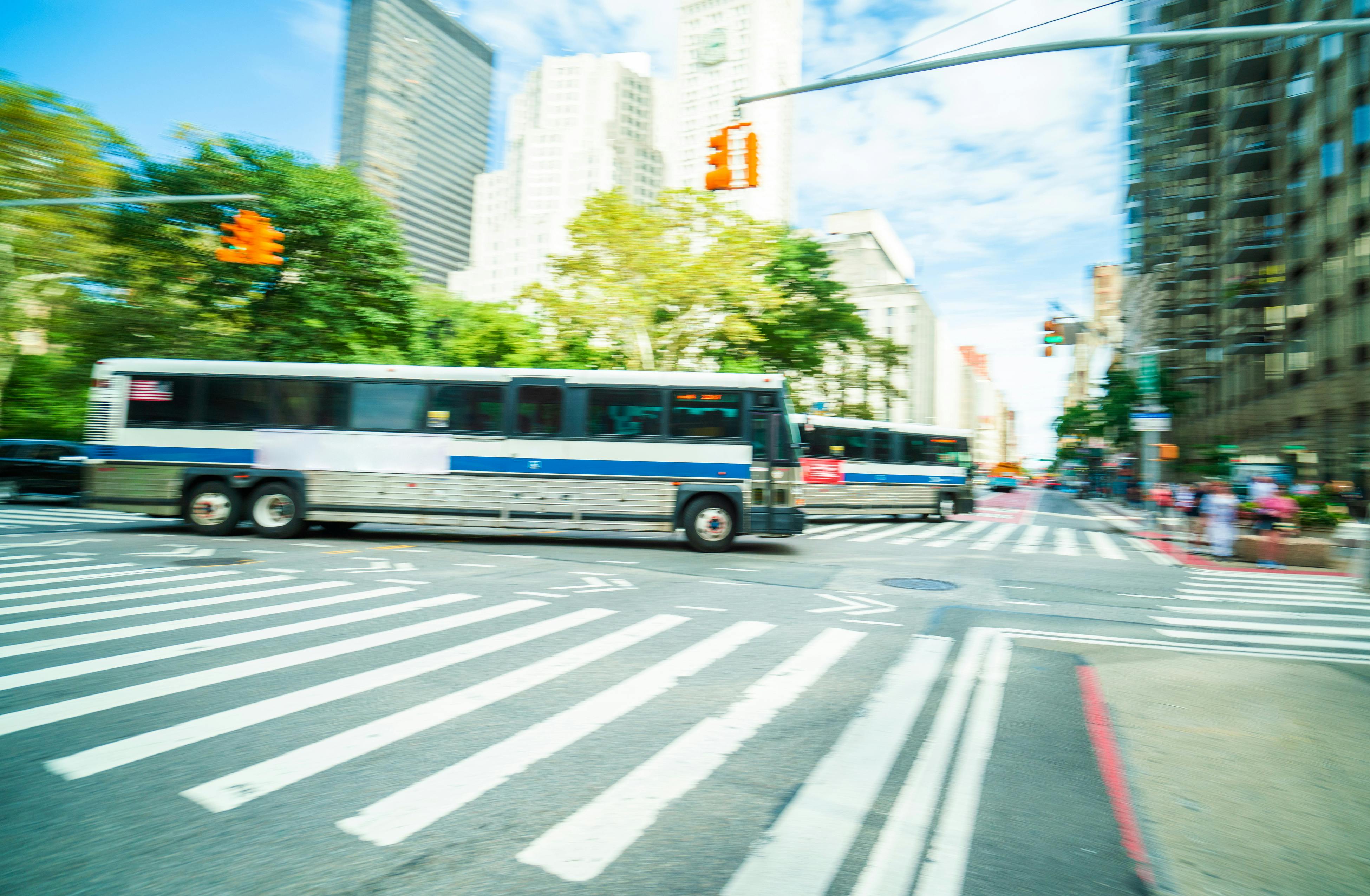 City bus driving through new york intersection