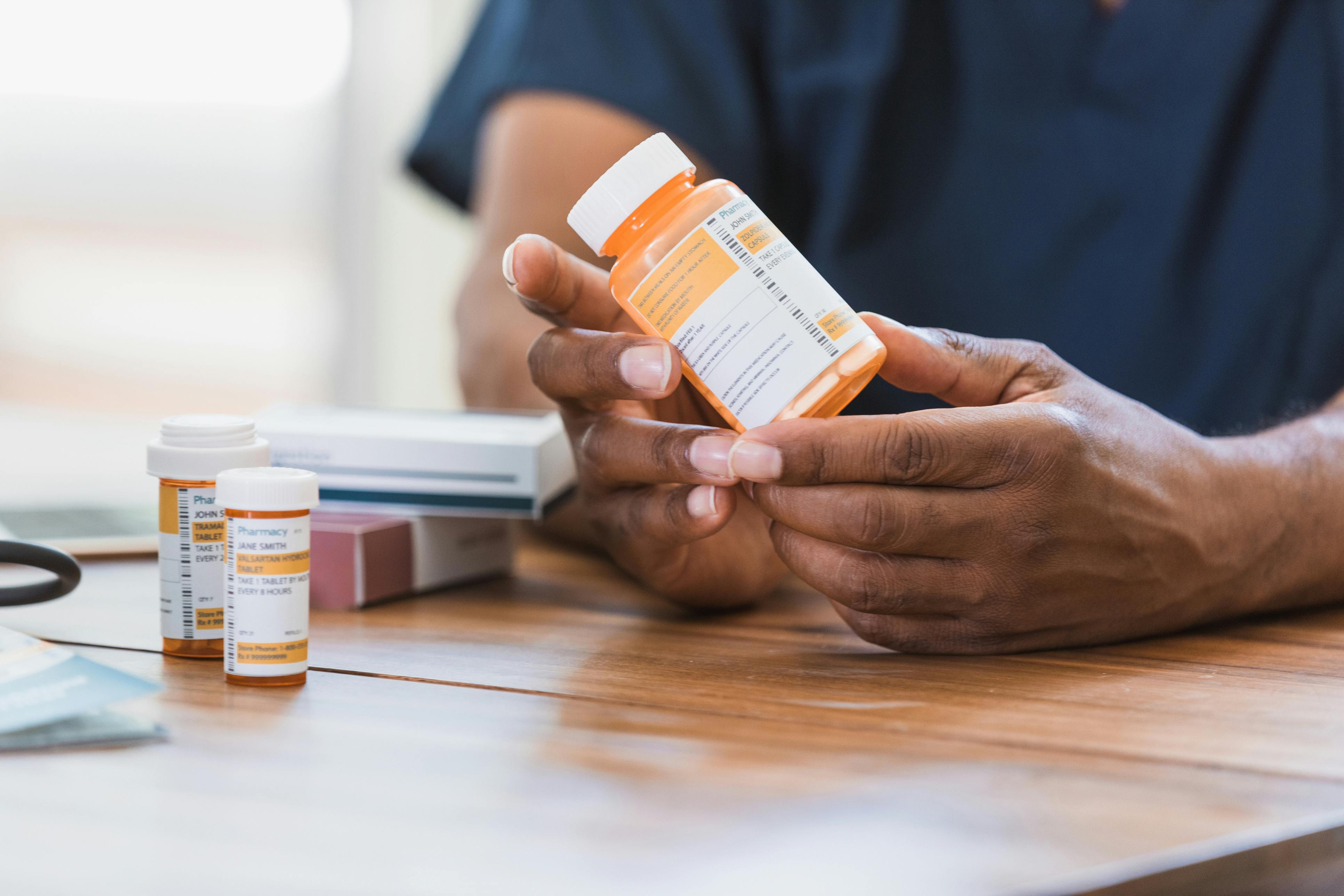 Man looking over warning label on prescribed medicine