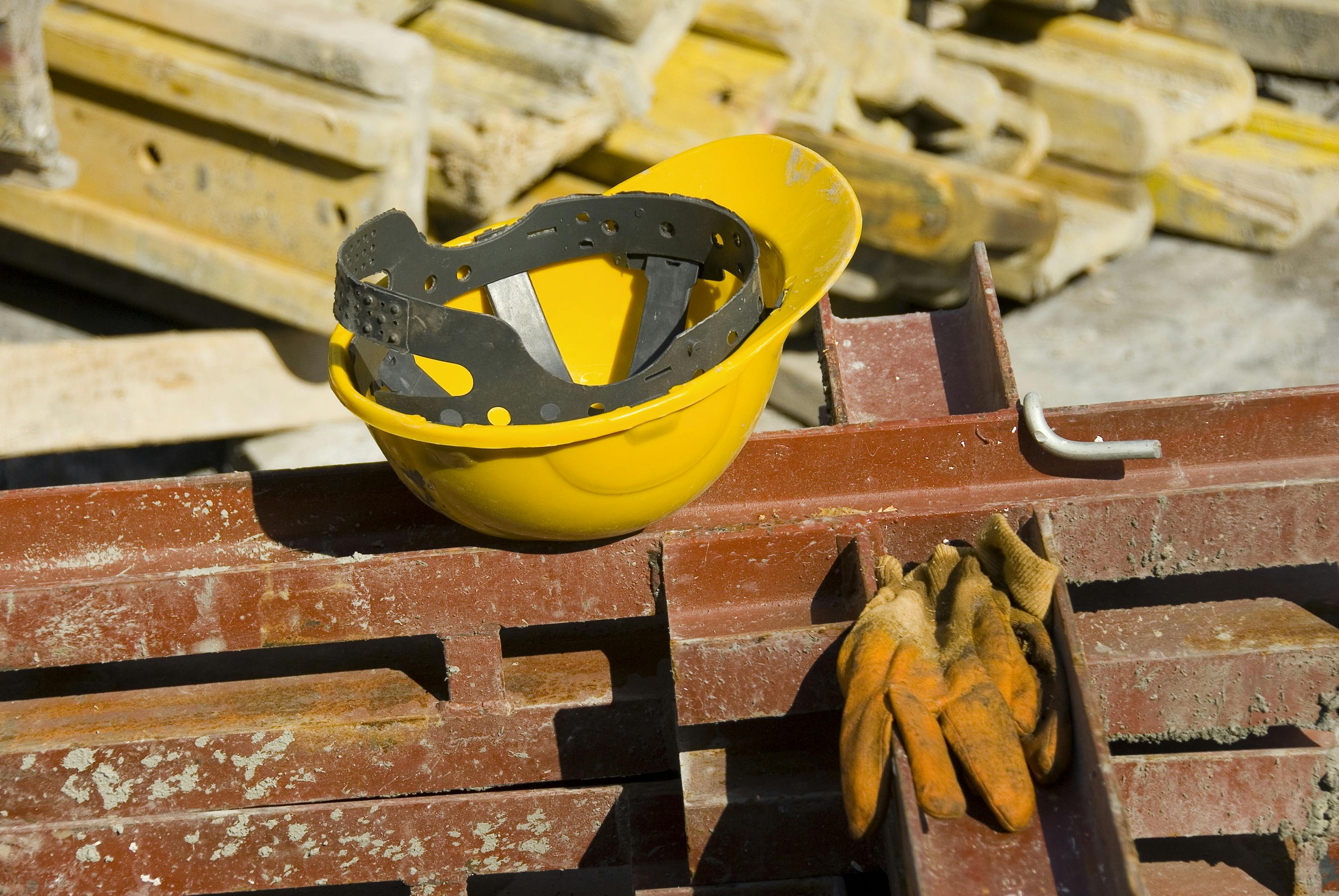 Construction hard hat sitting on brick wall