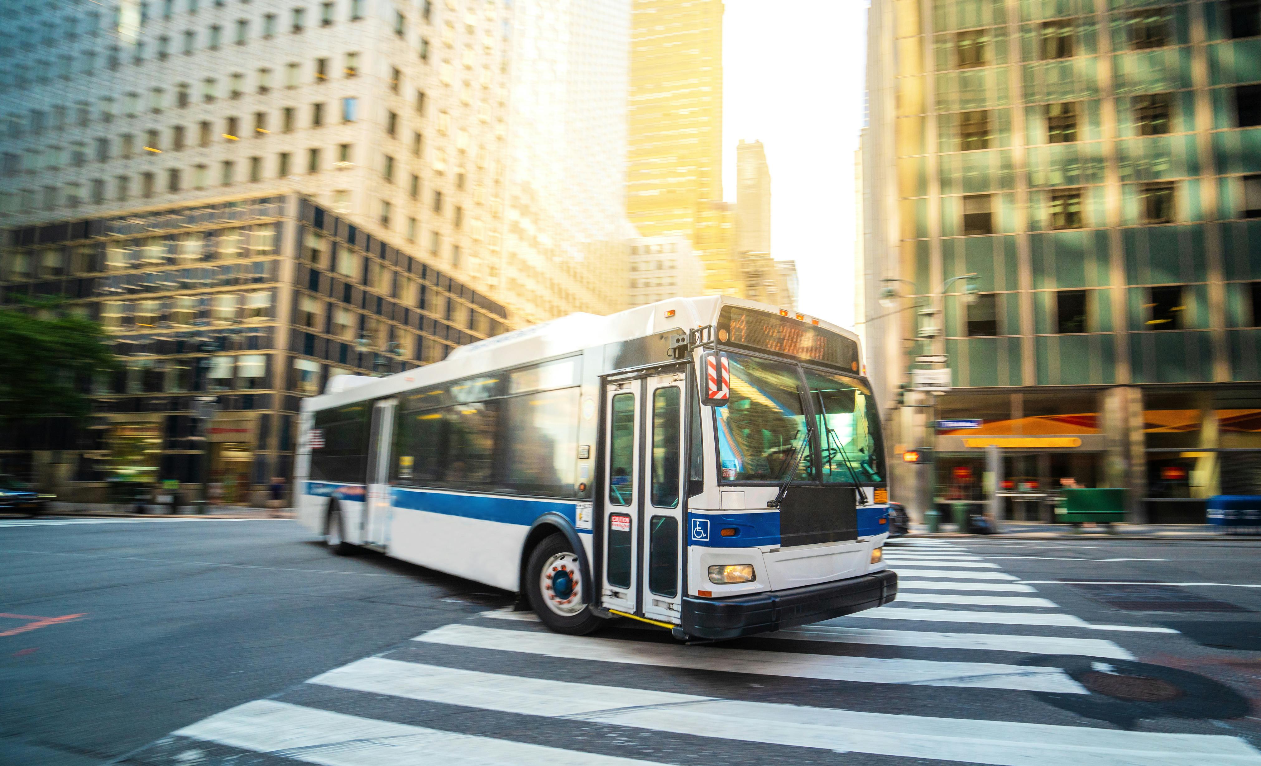 City bus driving through an NYC intersection