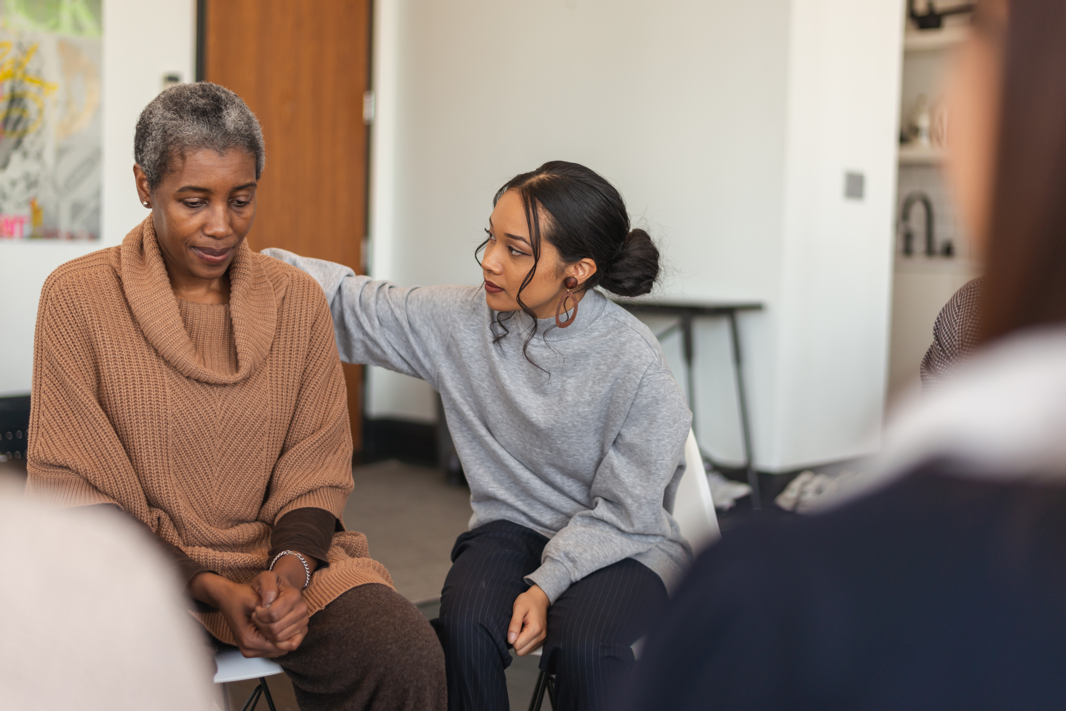 younger woman consoling an older woman