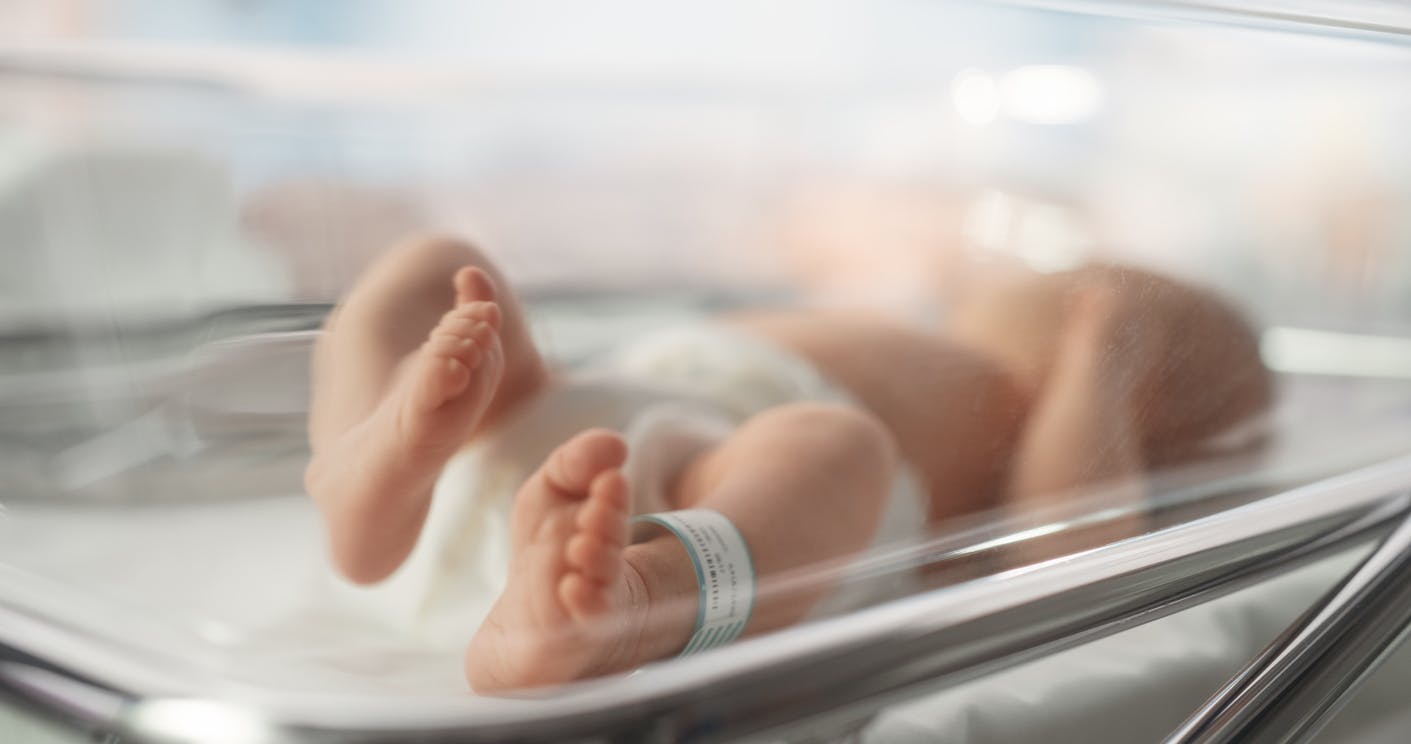 newborn baby in a basinet