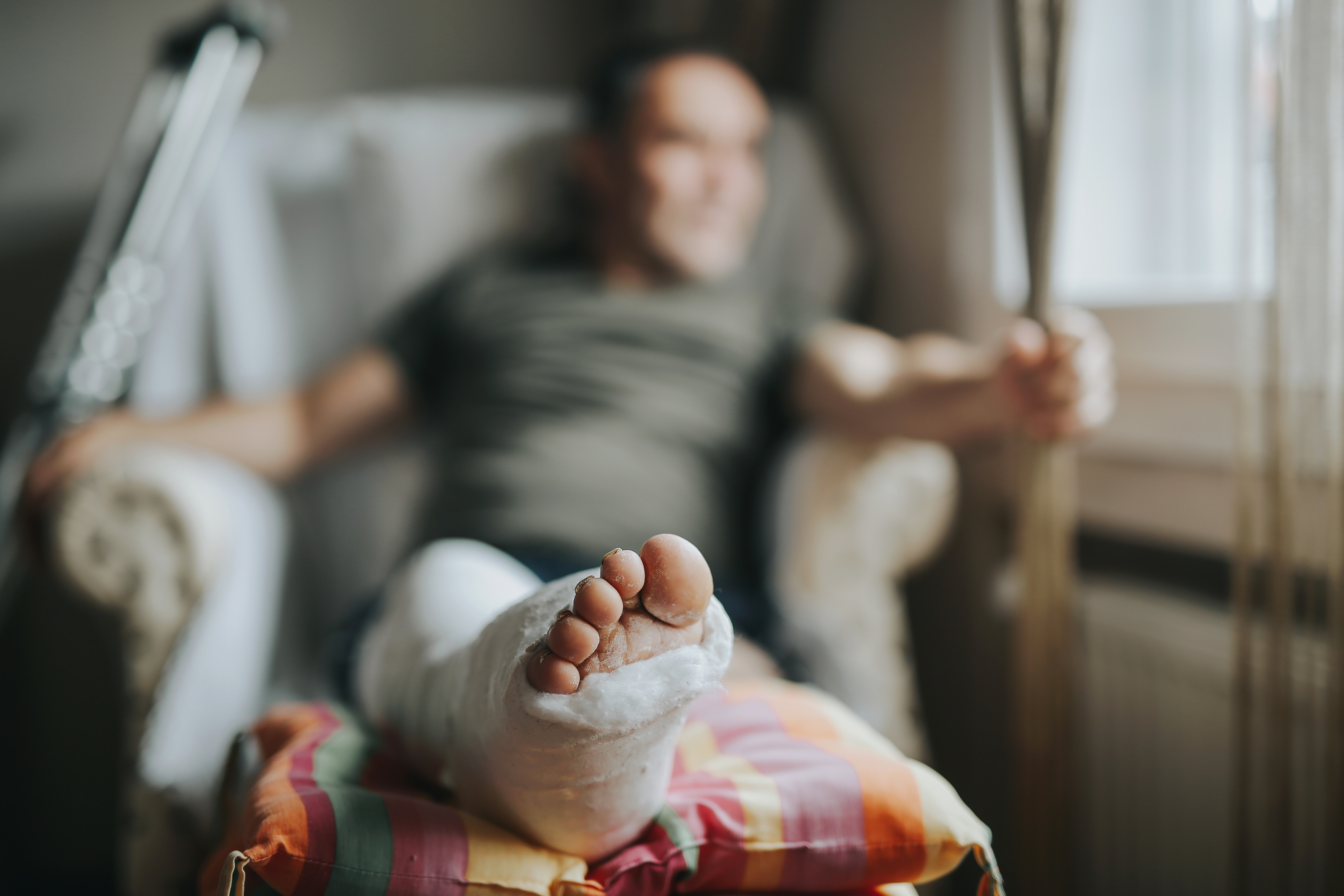 man sitting with broken leg