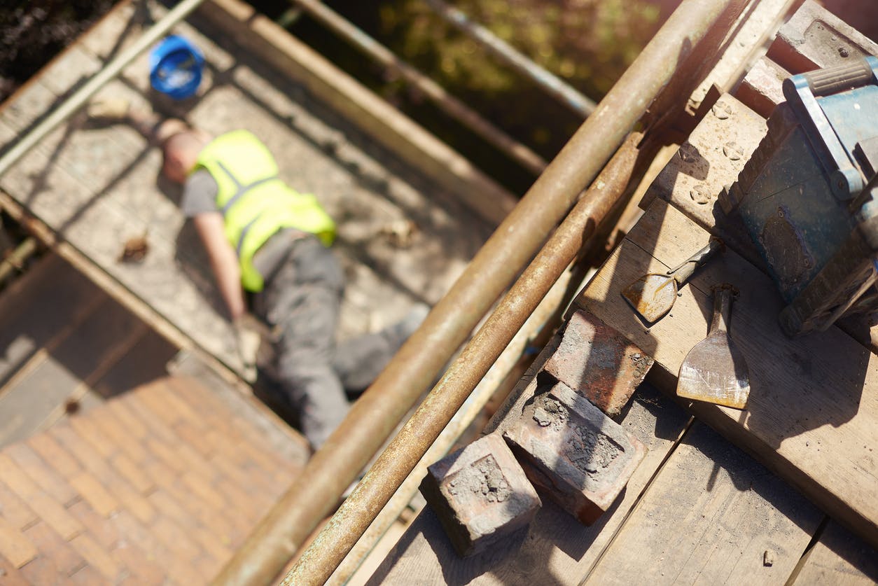 Worker who has fallen off a roof